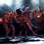 Boy riding a life-sized horse puppet