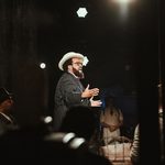 Singer in pinstripe suit and hat