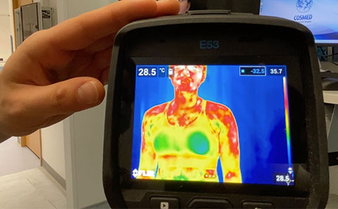 Heat scanner directed at sports bra