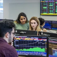 Students working at the Bloomberg terminals in the financial laboratory.