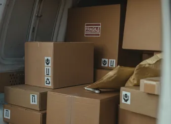 Pexels image of brown parcels stacked inside a delivery van